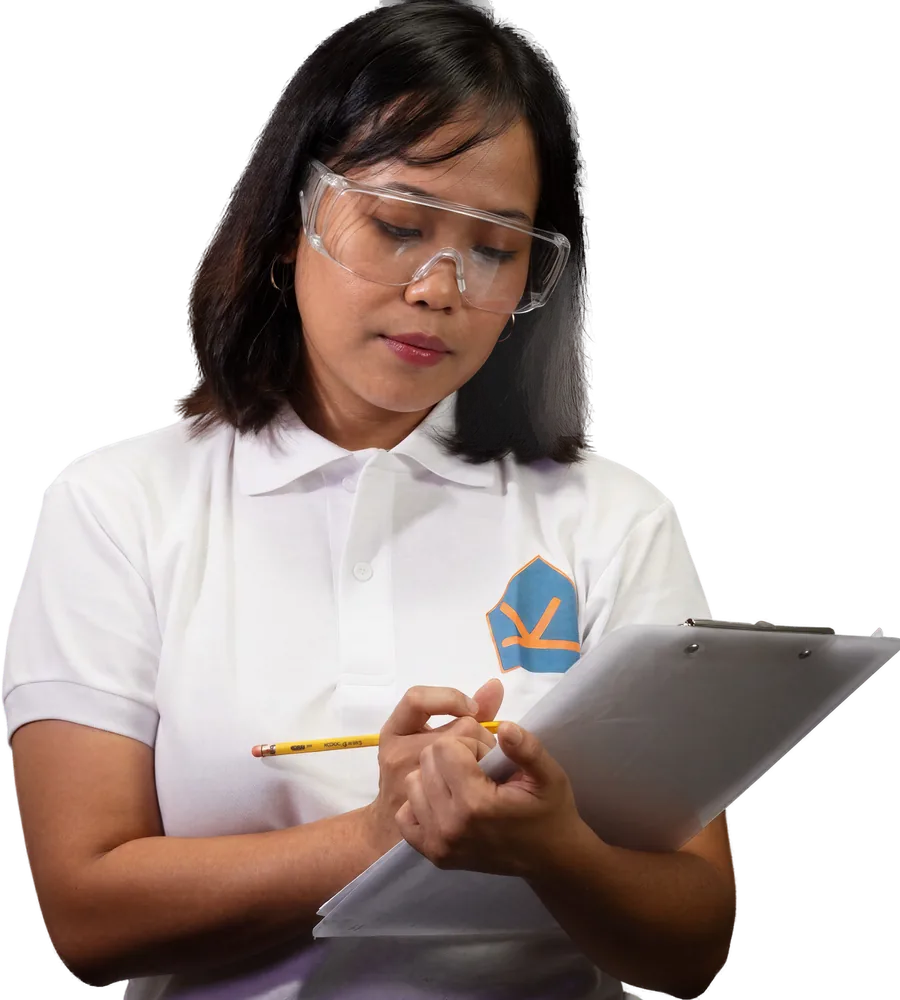 A KuyaYos technician noting an aircon check